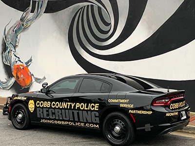 recruiting car in front of spiral mural